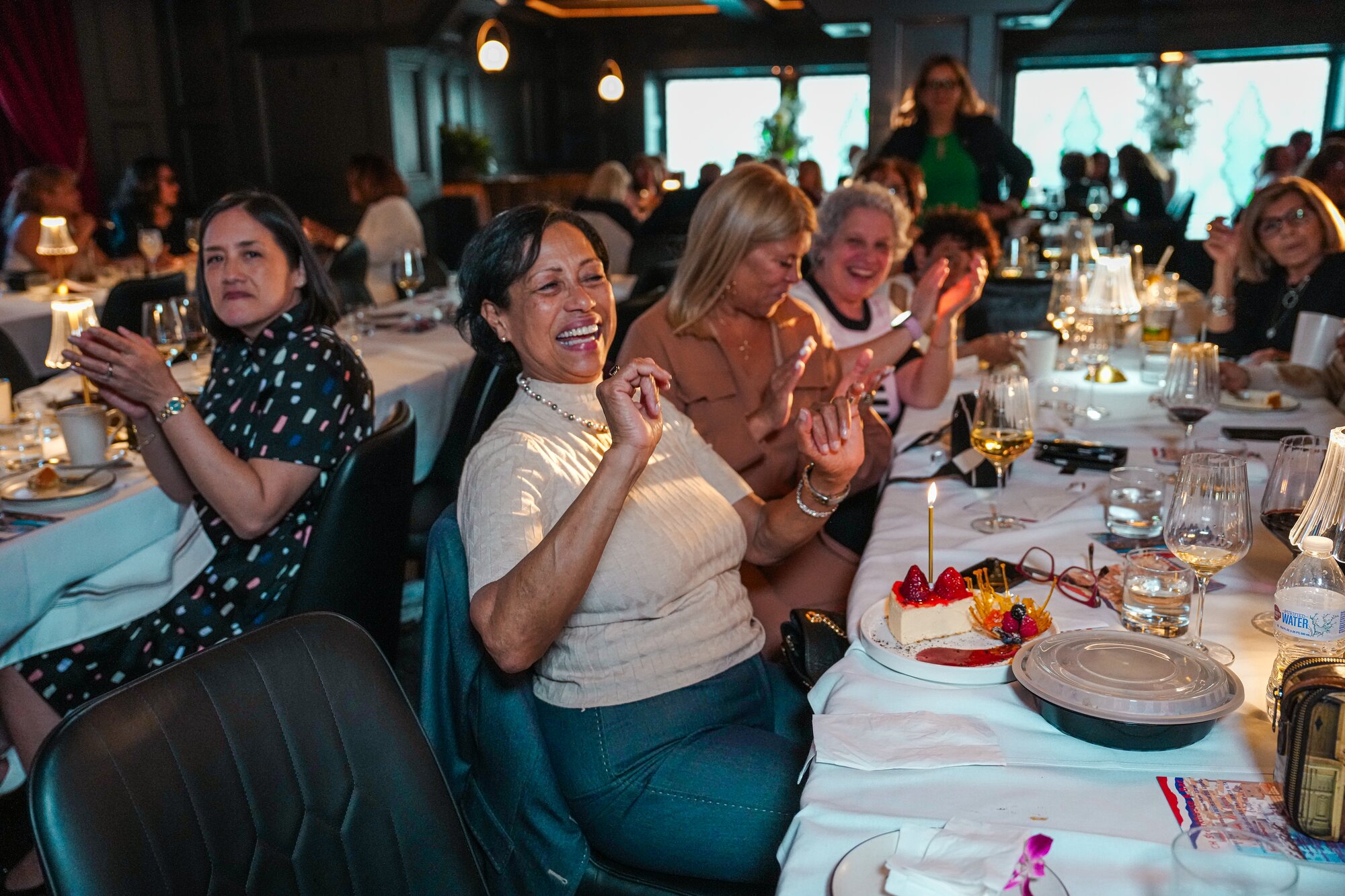 A table of guests applauding during a celebration