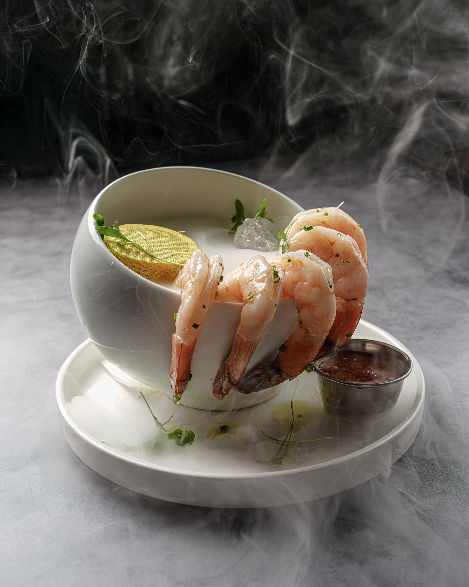 Chilled shrimp cocktail rimming a smoking bowl