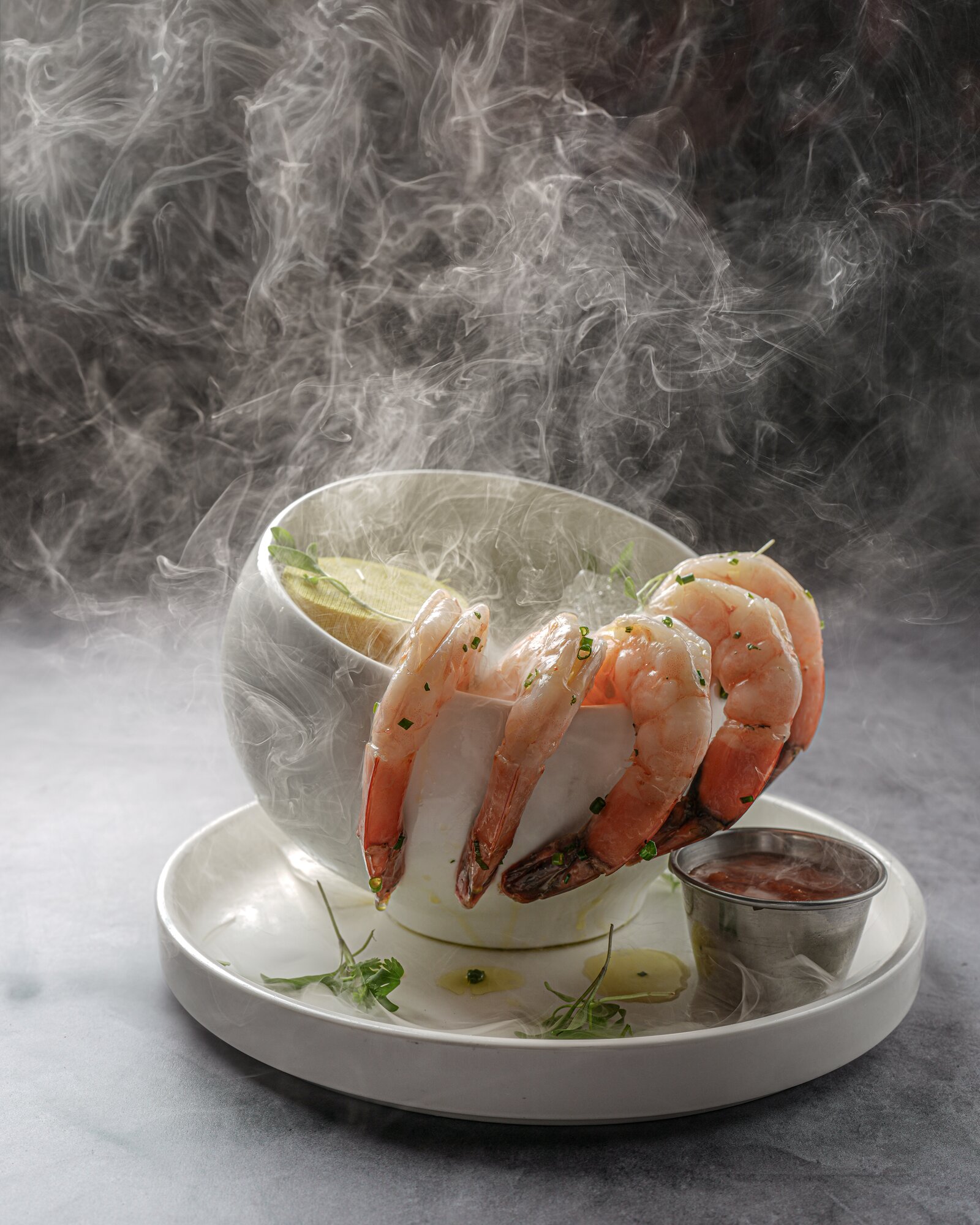 Jumbo shrimp cocktail wreathed in dry-ice smoke