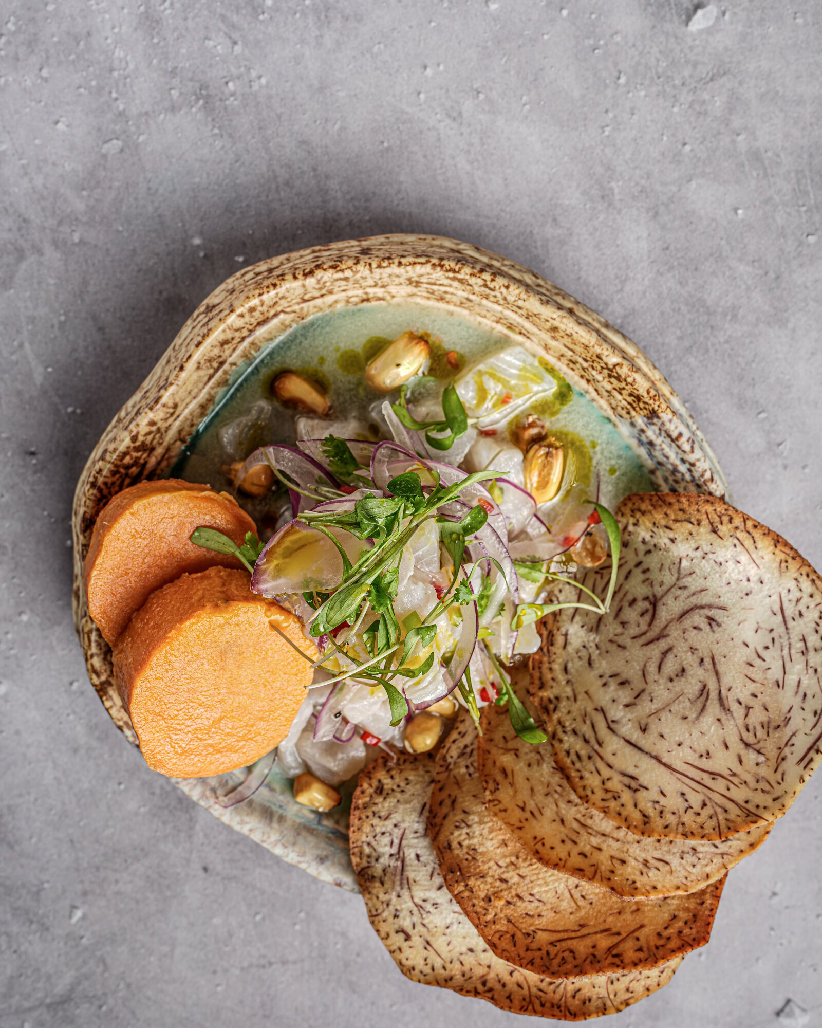 Overhead view of ceviche with sweet potato and taro chips