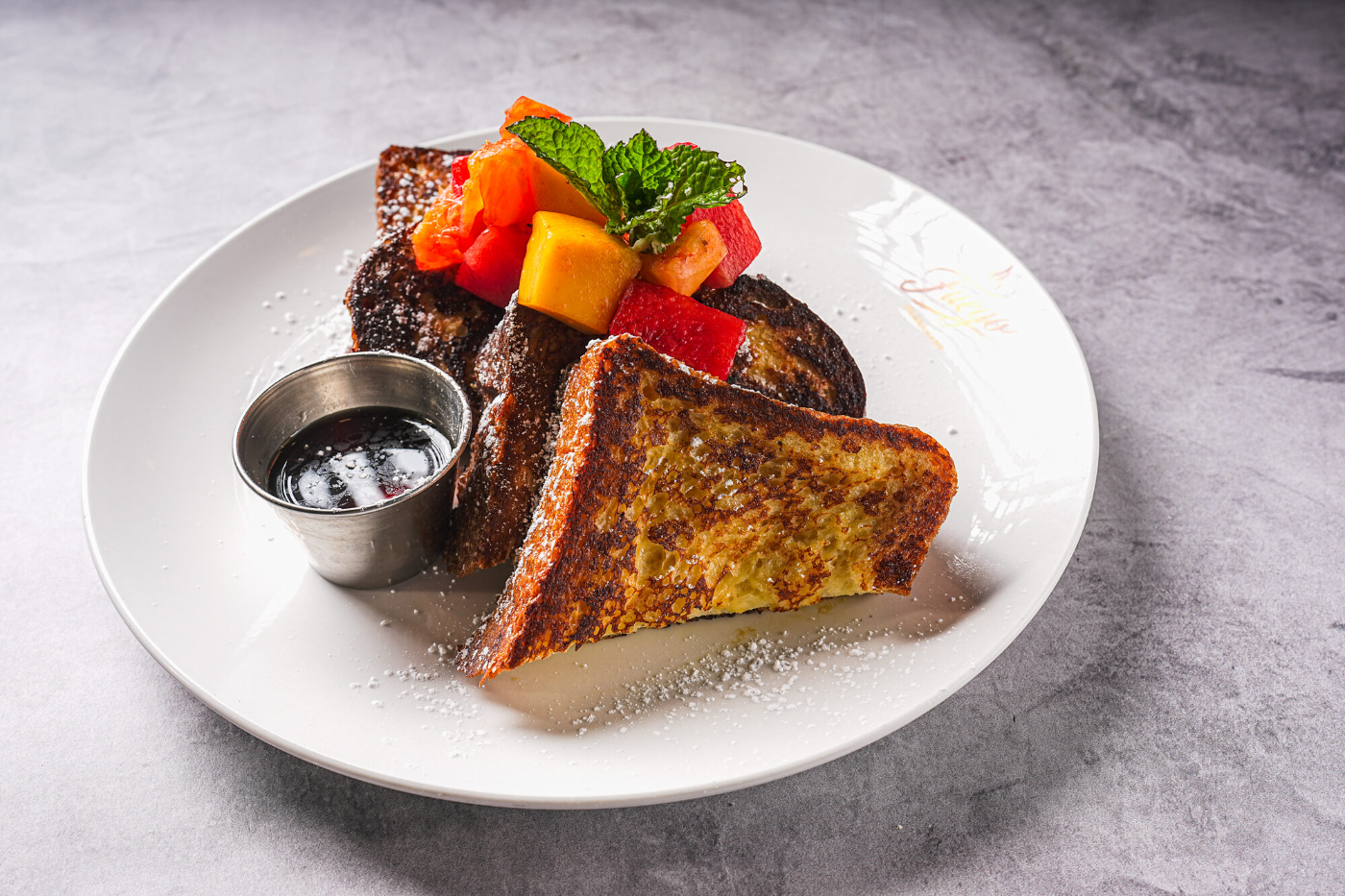 Stuffed French toast topped with fresh fruit and syrup