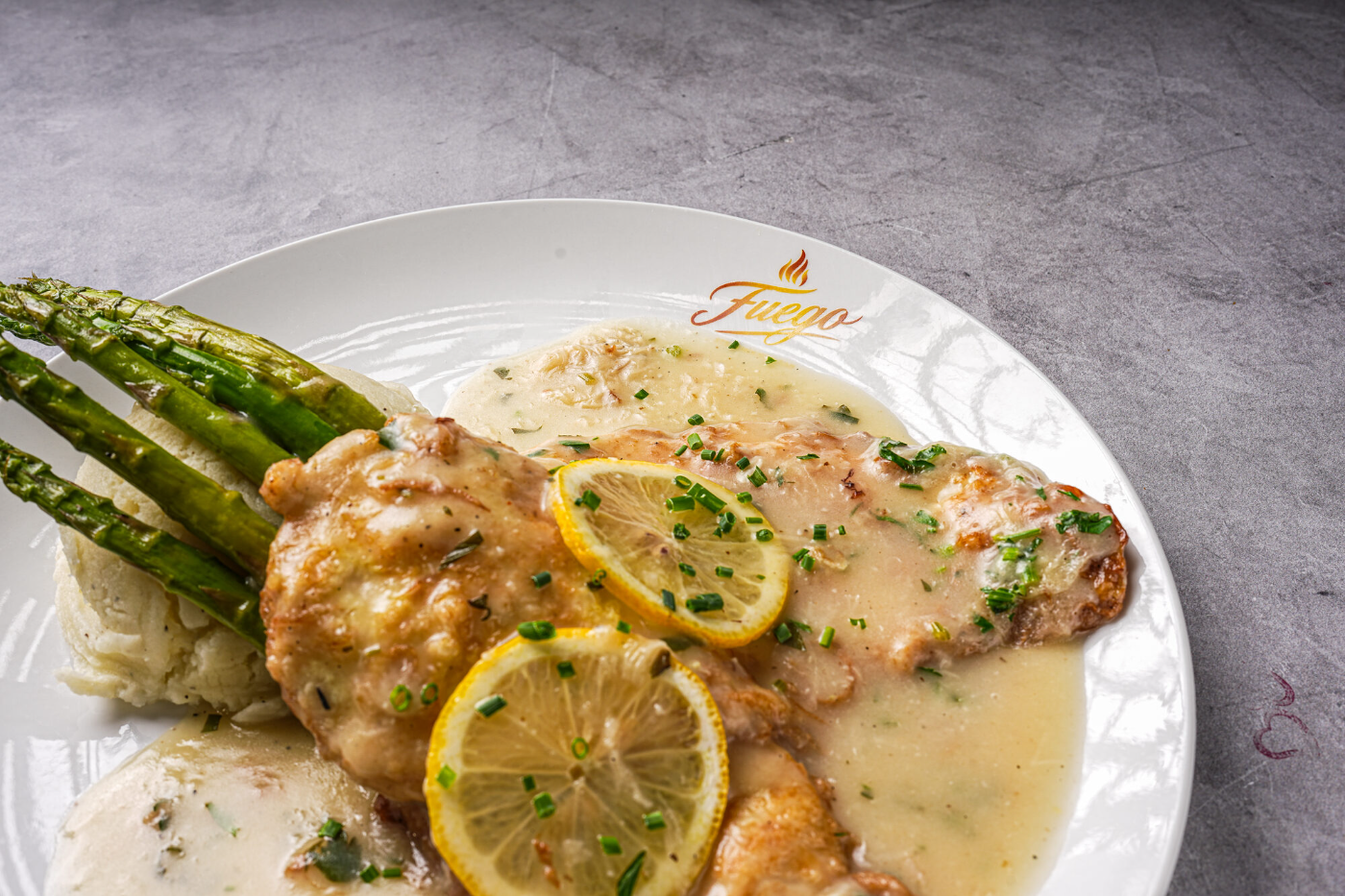 Chicken francese with grilled asparagus in lemon butter sauce