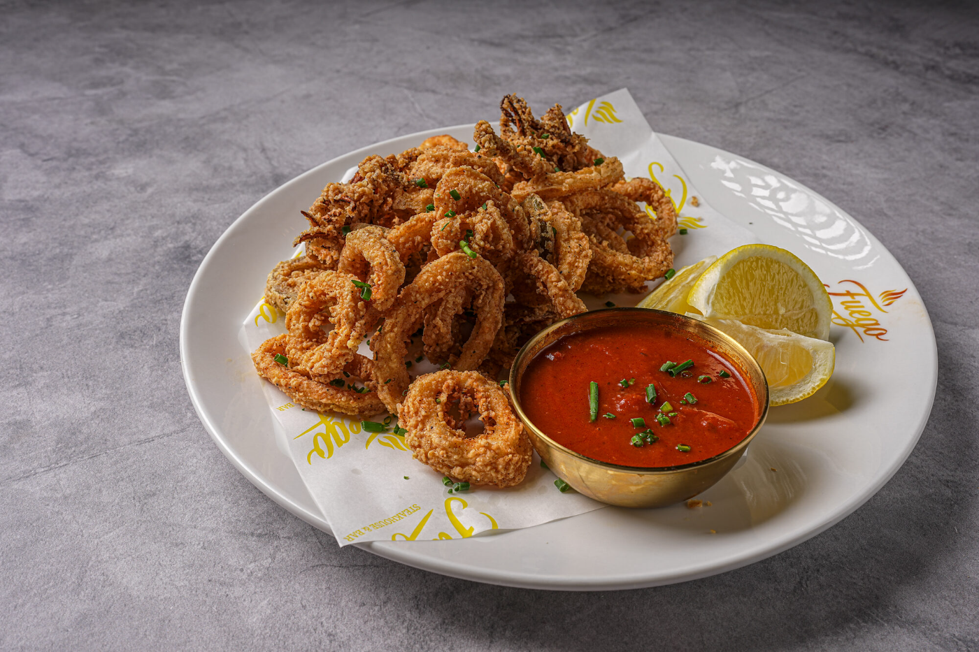 Golden fried calamari with marinara and lemon