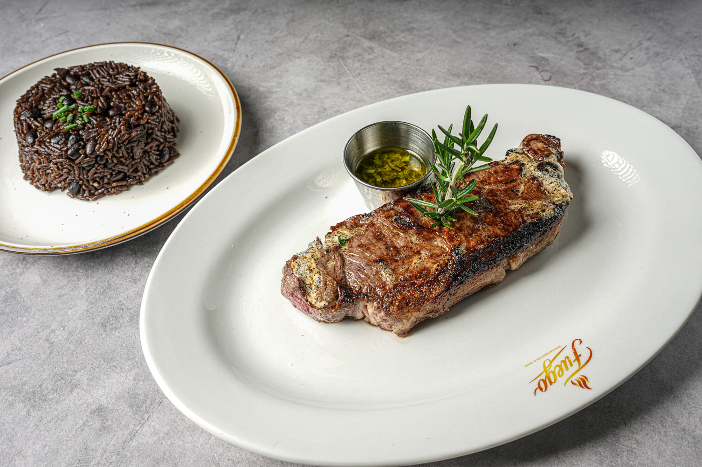 Grilled steak medallion with rice and morcilla