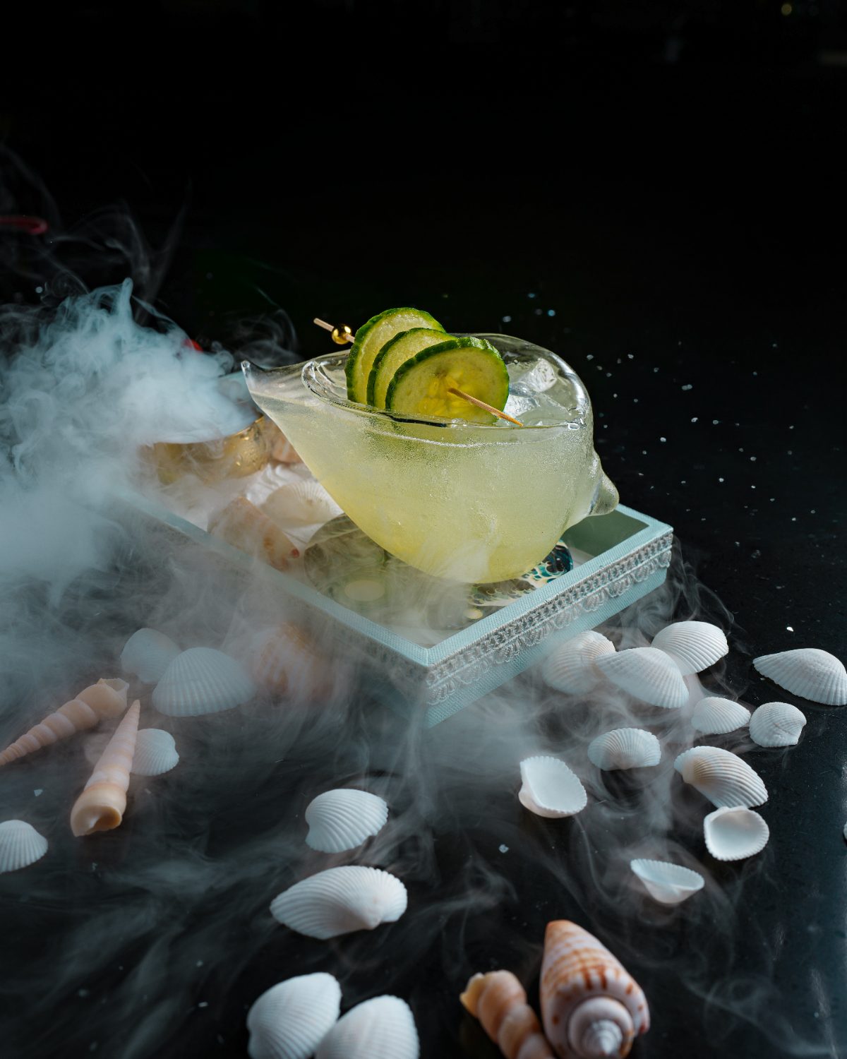 Cucumber cooler over ice with a veil of dry-ice mist
