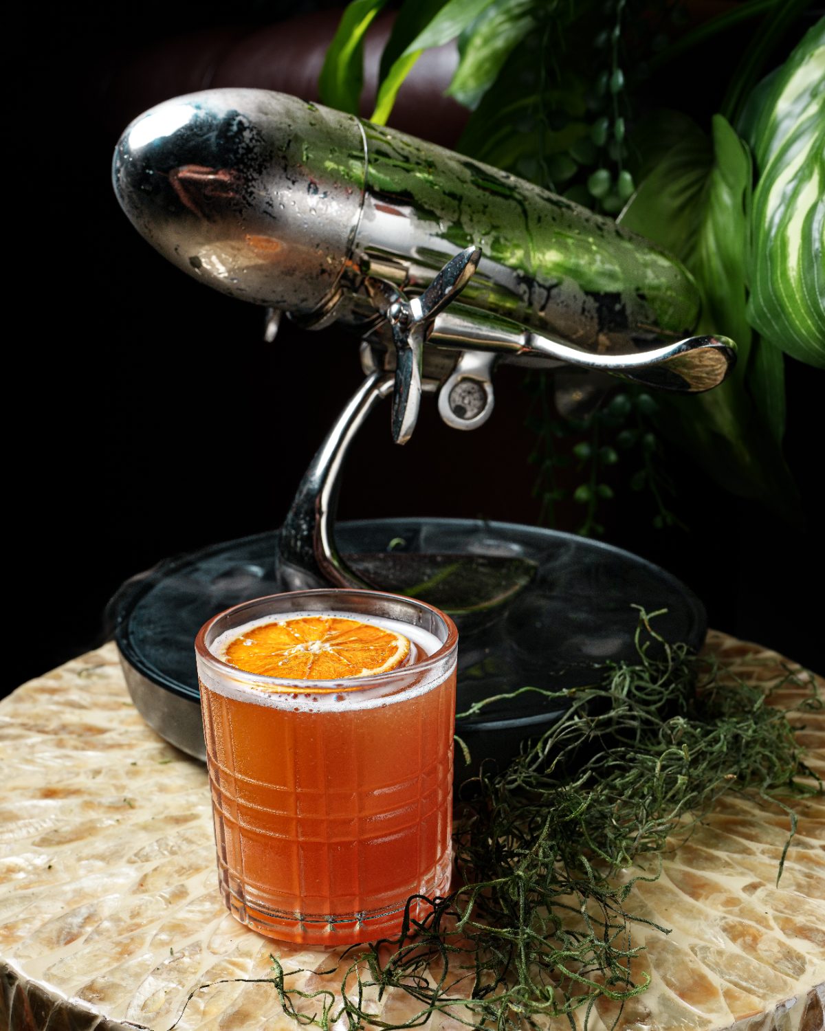 Dried-orange whiskey sour poured tableside from a vintage shaker