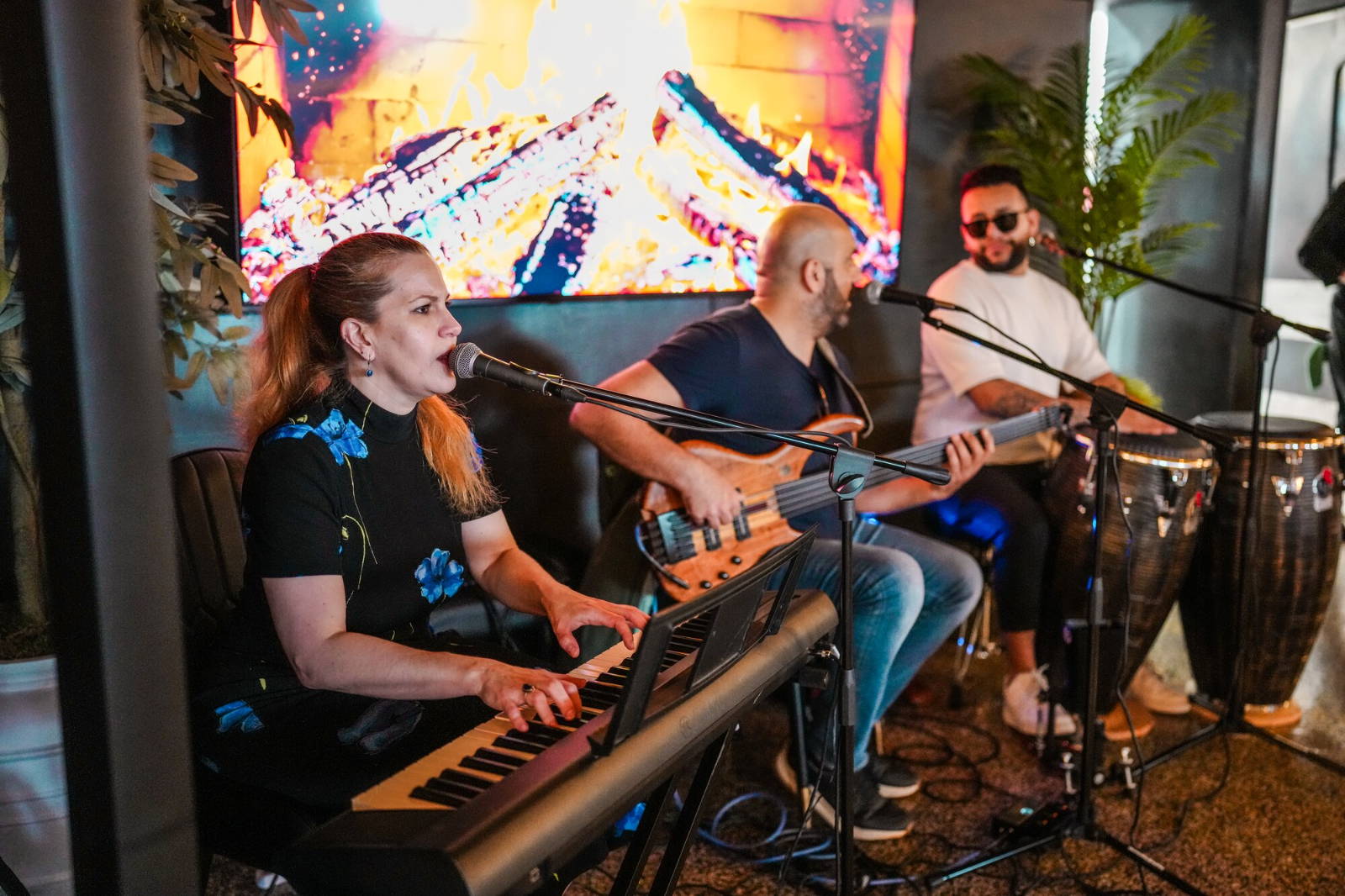 Live band performing — keys, bass and percussion — during an entertainment night at Fuego Steakhouse & Bar